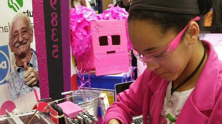 Madison wearing safety glasses and working on robotics project